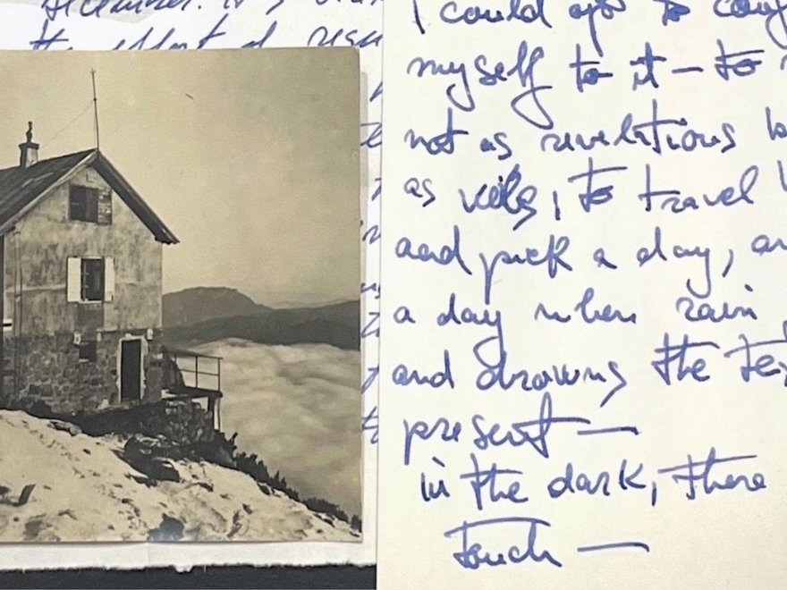 scrawled notes on scraps of paper with a sepia photo of a house